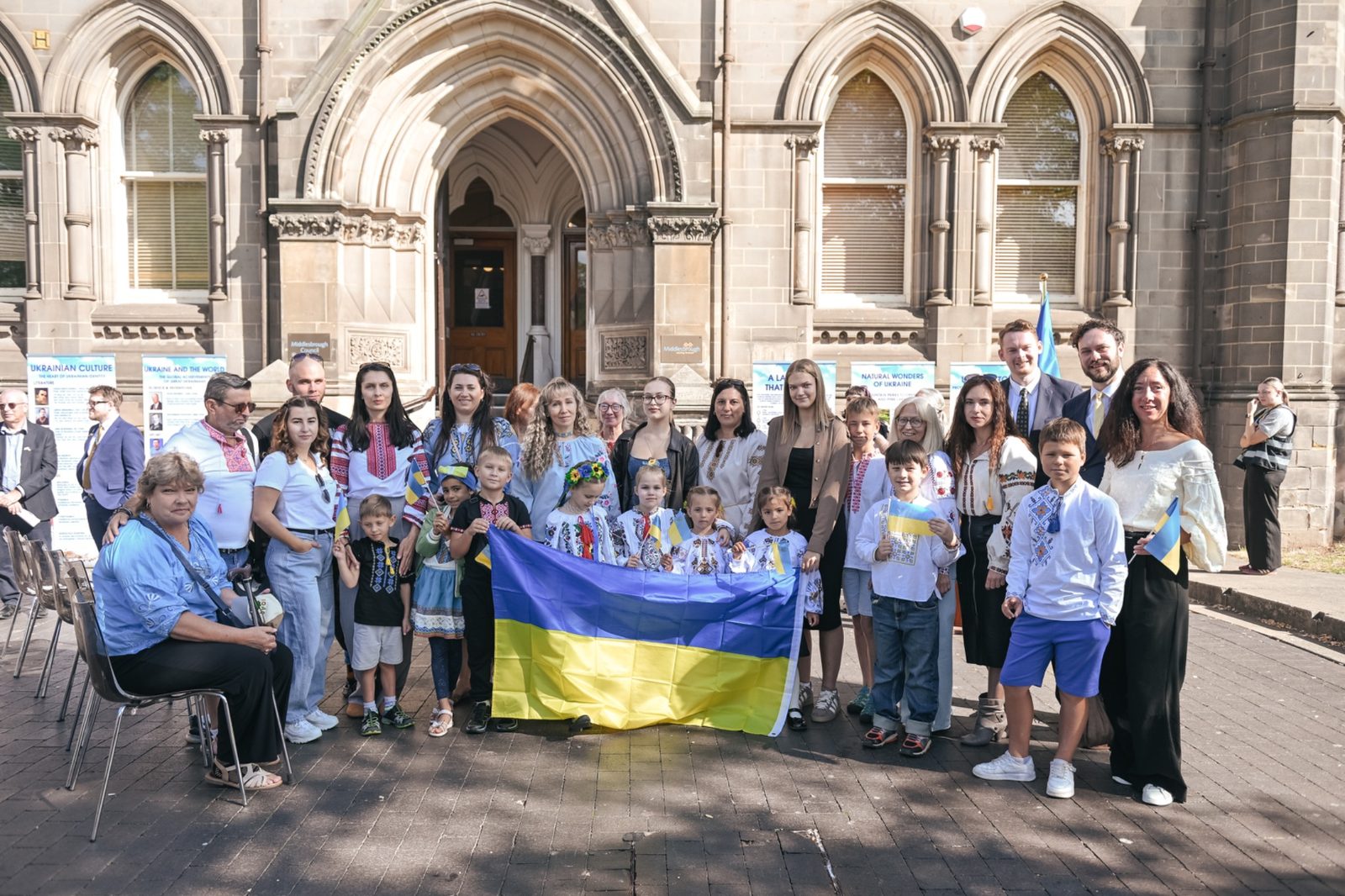 Families and community members gathered with the Ukrainian flag outside Middlesbrough Town Hall, many wearing traditional embroidered vyshyvanky.